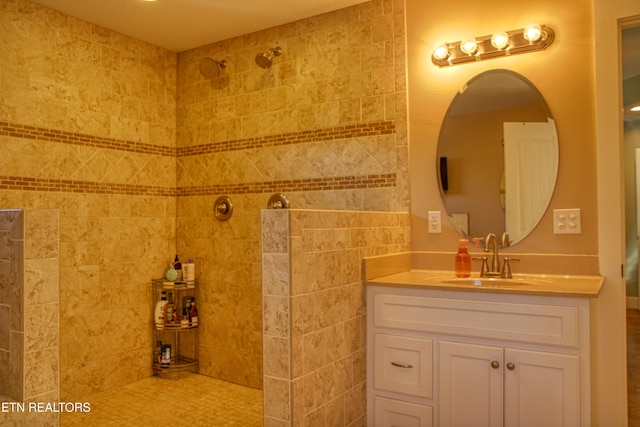 bathroom with vanity and tiled shower