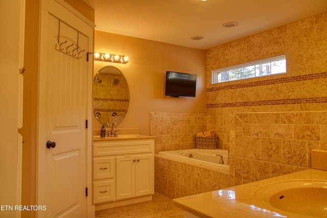 bathroom with vanity, tiled bath, and tile patterned floors