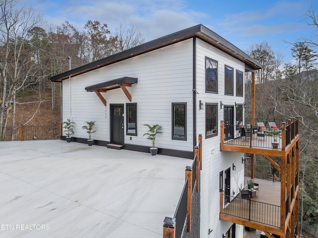 back of property with a balcony