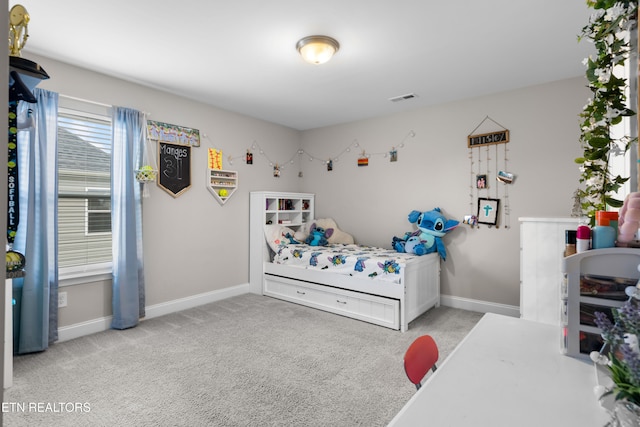 bedroom featuring light carpet