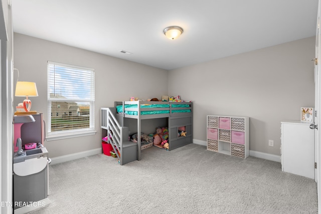 bedroom featuring light colored carpet