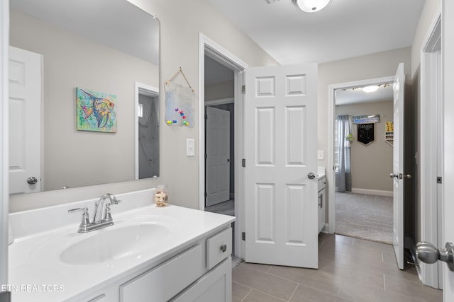 bathroom with tile patterned floors and vanity