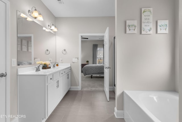 bathroom with vanity, a tub to relax in, and tile patterned floors