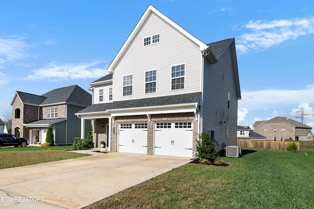 view of front facade with a front lawn, a garage, and central AC unit