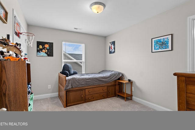 bedroom with light colored carpet