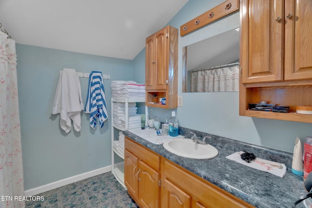 bathroom with vanity and vaulted ceiling