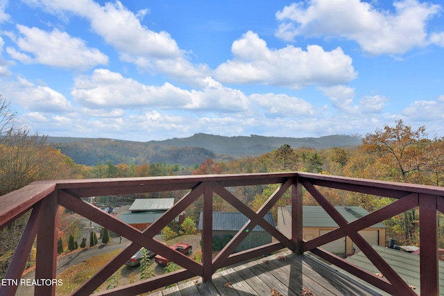 wooden deck with a mountain view