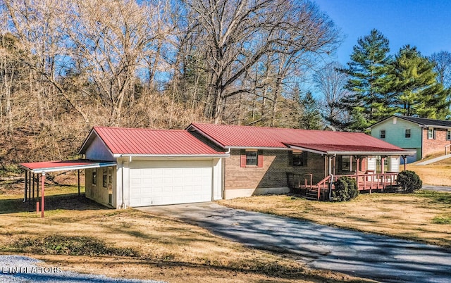 view of front of property with a garage, a front yard, and covered porch