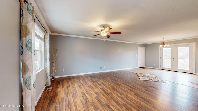 unfurnished room with hardwood / wood-style flooring, ceiling fan with notable chandelier, crown molding, and french doors