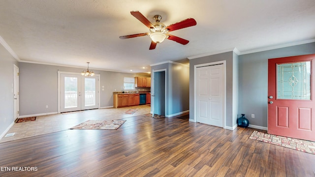 unfurnished living room featuring french doors, dark hardwood / wood-style floors, crown molding, and ceiling fan with notable chandelier