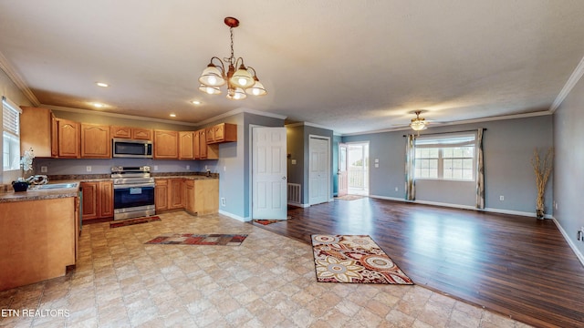 kitchen with stainless steel appliances, light hardwood / wood-style floors, hanging light fixtures, and crown molding