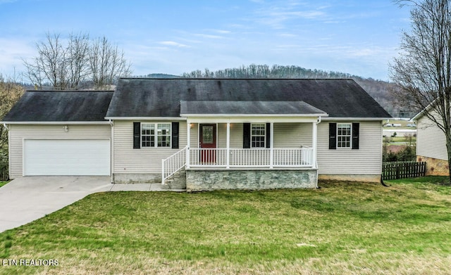 view of front of property featuring covered porch, driveway, a front lawn, and an attached garage