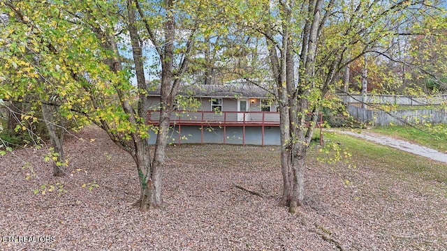 back of house with a wooden deck