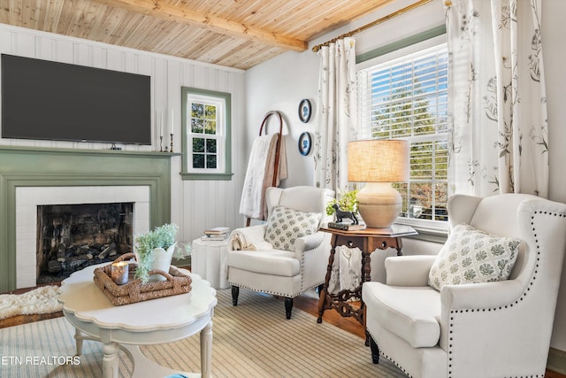 living area featuring a wealth of natural light, wooden ceiling, and beam ceiling