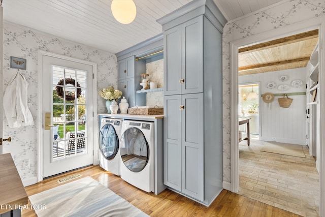 washroom with cabinets, light wood-type flooring, wood ceiling, and independent washer and dryer