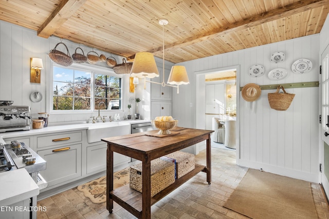 kitchen featuring sink, wooden ceiling, stainless steel dishwasher, pendant lighting, and beam ceiling