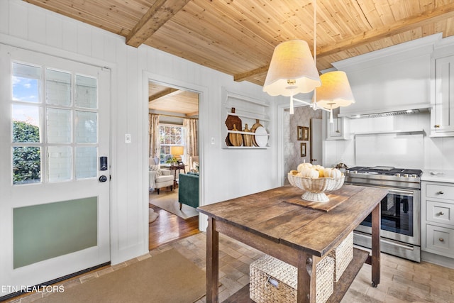 dining area with wood ceiling, beam ceiling, and wood walls