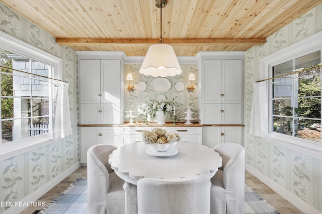 dining area featuring beamed ceiling and wooden ceiling