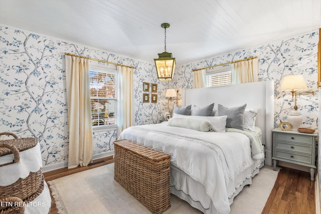 bedroom with hardwood / wood-style flooring and wooden ceiling