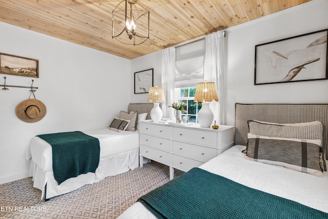 bedroom with carpet flooring, an inviting chandelier, and wood ceiling