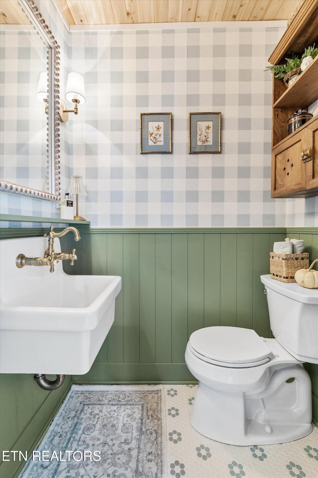 bathroom featuring tile patterned flooring, sink, wood ceiling, and toilet