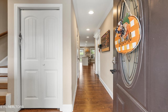 corridor with dark hardwood / wood-style floors and ornamental molding