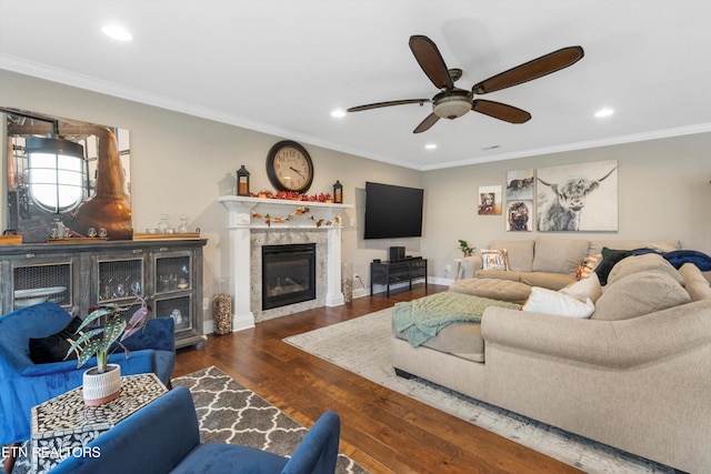 living room with ceiling fan, dark wood-type flooring, and ornamental molding