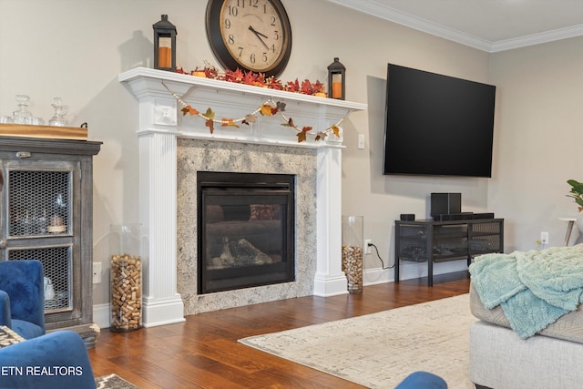 living room with a fireplace, crown molding, and dark hardwood / wood-style flooring