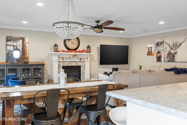 living room featuring wood-type flooring, a premium fireplace, and crown molding