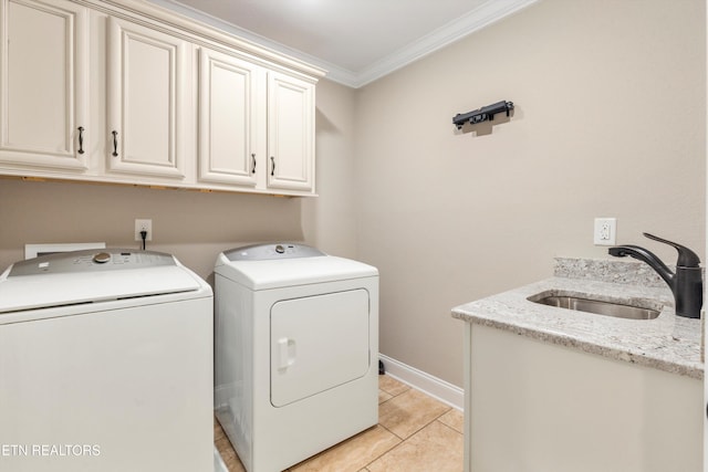 clothes washing area featuring sink, cabinets, independent washer and dryer, crown molding, and light tile patterned floors