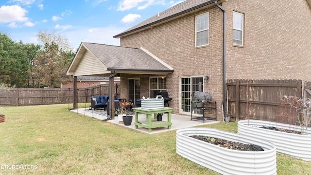 rear view of property with outdoor lounge area, a yard, and a patio