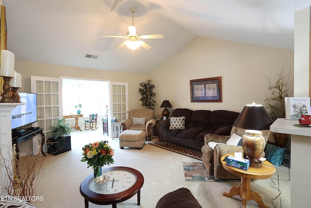 carpeted living room featuring ceiling fan and vaulted ceiling