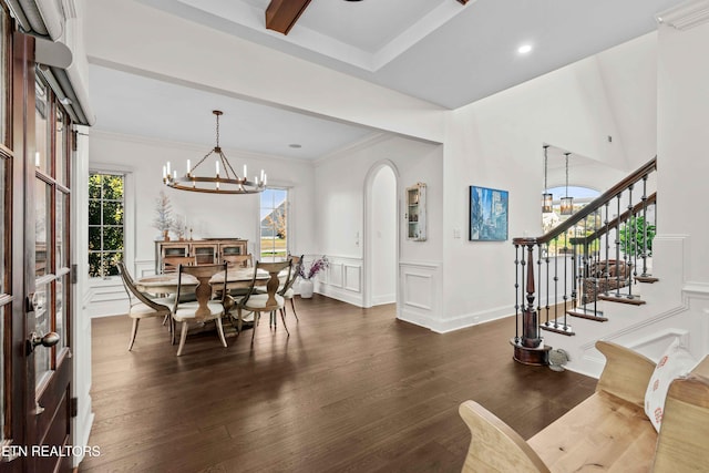 dining area featuring dark hardwood / wood-style flooring, crown molding, and an inviting chandelier