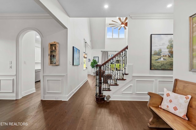 interior space with dark wood-type flooring and ornamental molding