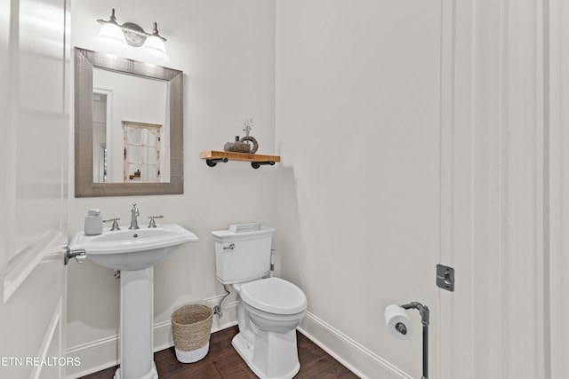 bathroom featuring hardwood / wood-style floors, toilet, and sink