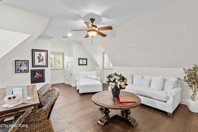 living room featuring hardwood / wood-style floors, ceiling fan, and vaulted ceiling