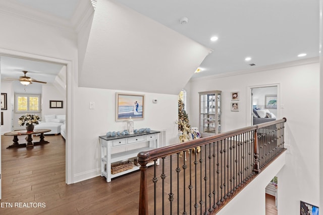 hallway with lofted ceiling, dark hardwood / wood-style floors, and crown molding