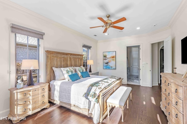 bedroom with dark hardwood / wood-style flooring, ceiling fan, multiple windows, and connected bathroom