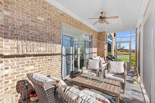 sunroom / solarium featuring ceiling fan