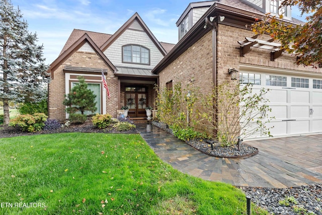 view of front of home with a garage, a front yard, and french doors