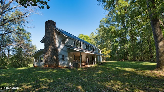 view of side of home featuring a lawn