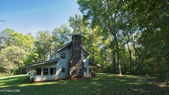 view of side of home with a lawn