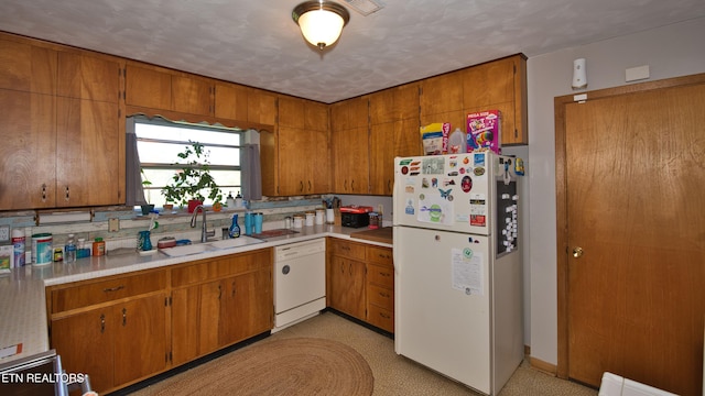 kitchen with white appliances and sink