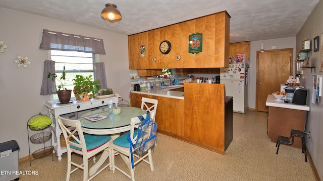 kitchen with a textured ceiling and white refrigerator