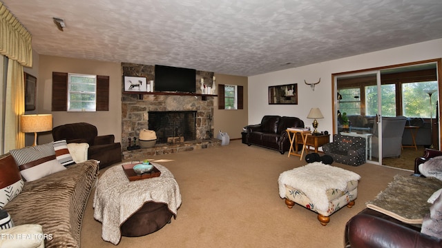 carpeted living room featuring a fireplace, plenty of natural light, and a textured ceiling