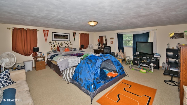 bedroom featuring light colored carpet and a textured ceiling