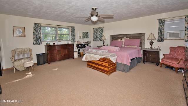 carpeted bedroom featuring cooling unit, a textured ceiling, and ceiling fan