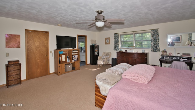 carpeted bedroom with ceiling fan and a textured ceiling