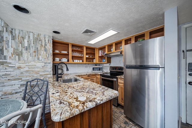 kitchen featuring stainless steel appliances, kitchen peninsula, decorative backsplash, sink, and exhaust hood