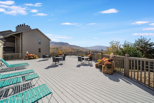 wooden deck with a mountain view